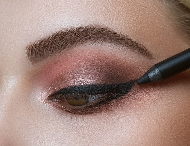 An eyeliner is applied along the lash line