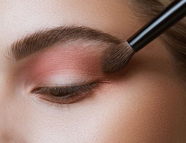 A brown eyeshadow is applied to the outer corner of the eye