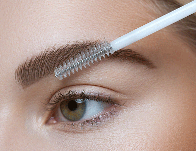 Eyebrows are defined with a brow pencil and gel