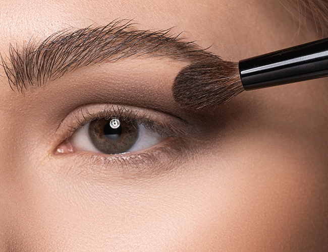 A brown eyeshadow is applied to the lid crease and upper and lower eyelid  