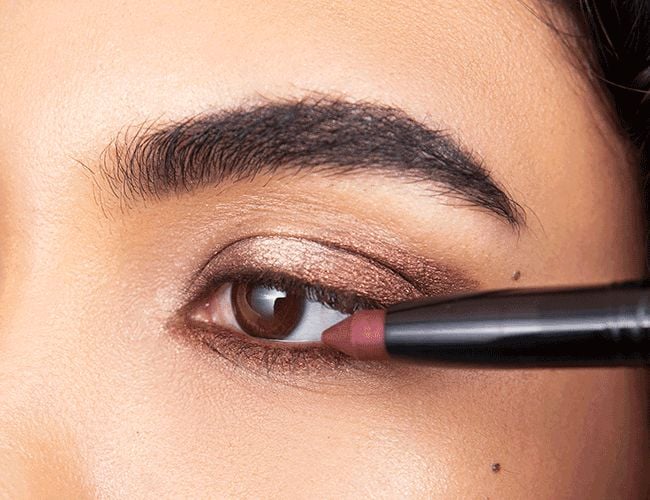 The waterline is emphasized with a brownish eye shadow 